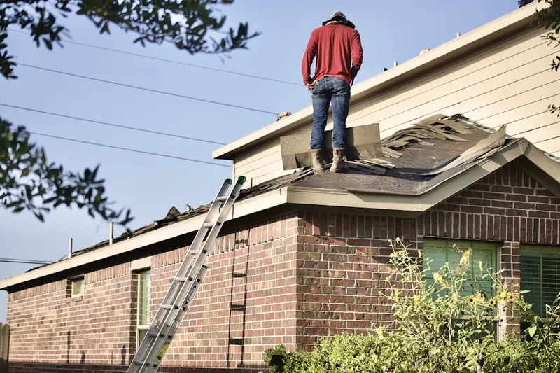 Professional roofer working on a residential roof in Clover